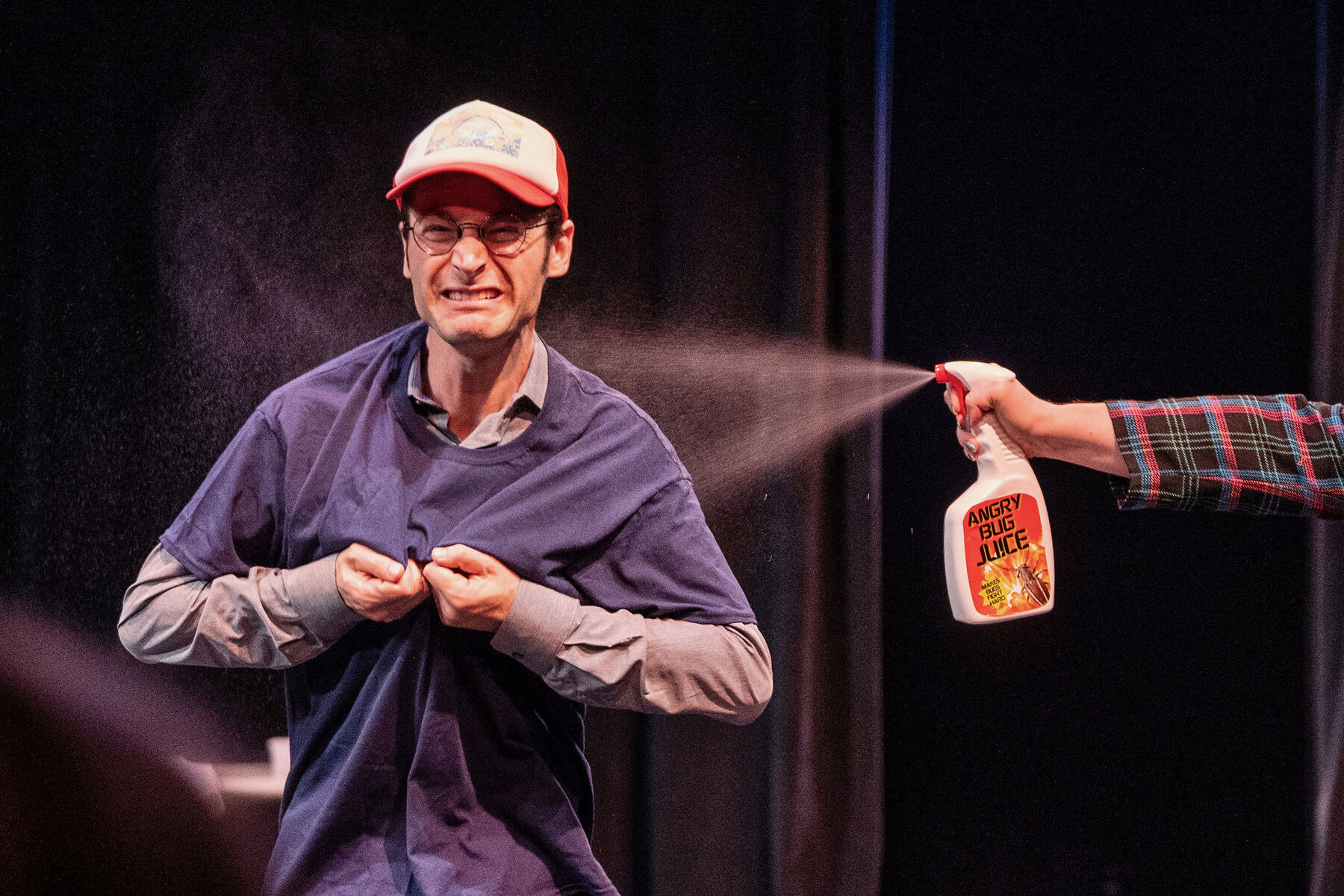 Jacob getting sprayed with Angry Bug Lice during a live sketch