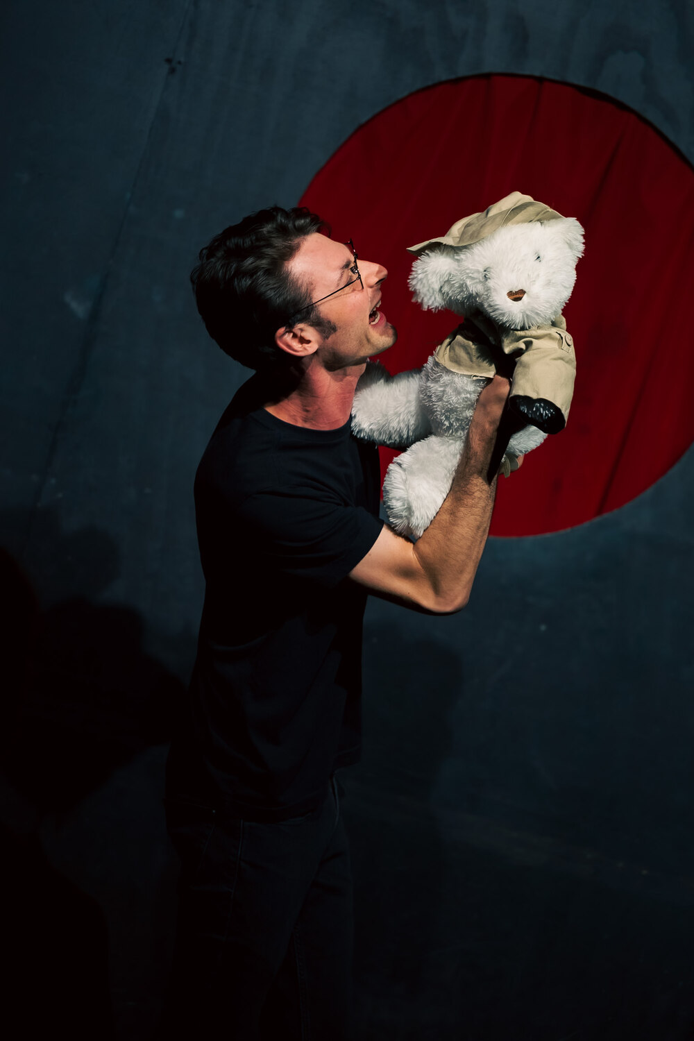 Jacob arguing with a teddy bear onstage